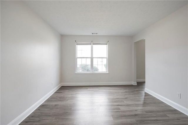 2682 Field Spring Dr, Lithonia, GA 30058 - unfurnished room with wood finished floors, baseboards, and a textured ceiling