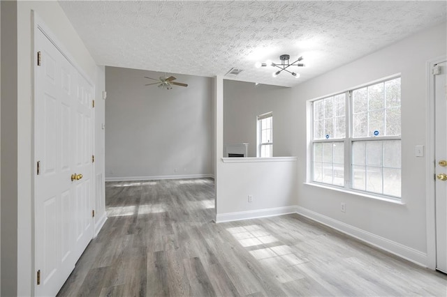 2682 Field Spring Dr, Lithonia, GA 30058 - unfurnished dining area featuring wood finished floors, a textured ceiling, a ceiling fan, baseboards, and a chandelier