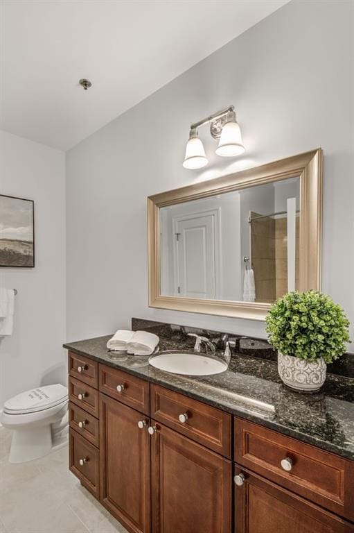 325 E Paces Ferry Rd NE Unit 410, Atlanta, GA 30305 - bathroom with toilet, vanity, a shower, and tile patterned flooring