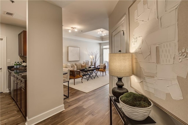 325 E Paces Ferry Rd NE Unit 410, Atlanta, GA 30305 - hall featuring dark wood finished floors and a tray ceiling