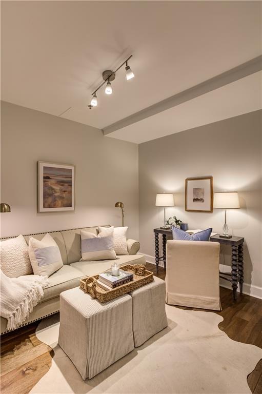 325 E Paces Ferry Rd NE Unit 410, Atlanta, GA 30305 - living room featuring baseboards, wood finished floors, and rail lighting