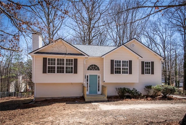 bi-level home featuring a chimney