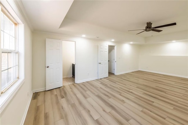 interior space featuring light wood-type flooring, plenty of natural light, and baseboards