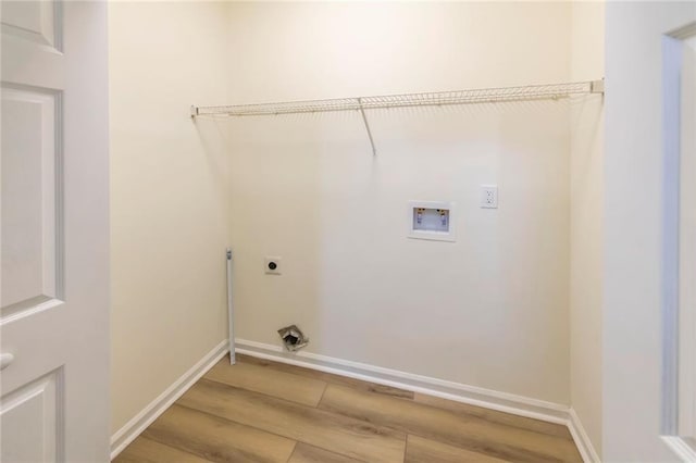 laundry area featuring light wood-type flooring, hookup for a washing machine, baseboards, and electric dryer hookup