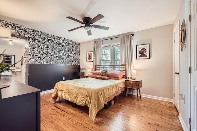 bedroom with hardwood / wood-style floors and ceiling fan