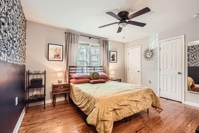 bedroom with ceiling fan and hardwood / wood-style flooring