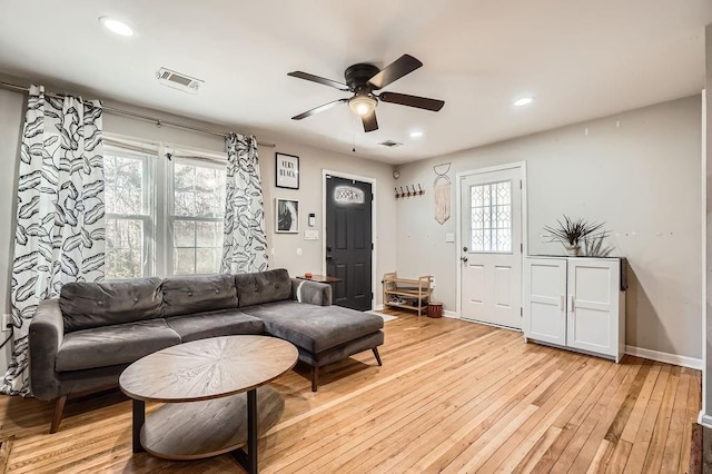 living room with ceiling fan and light wood-type flooring