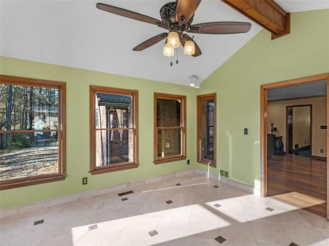spare room featuring tile patterned floors, visible vents, a ceiling fan, vaulted ceiling with beams, and baseboards