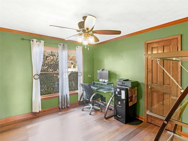 office area featuring wood finished floors, a ceiling fan, baseboards, and ornamental molding