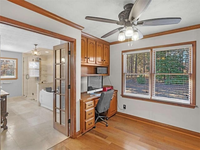 office with a healthy amount of sunlight, crown molding, baseboards, and ceiling fan with notable chandelier