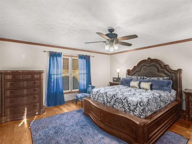 bedroom featuring baseboards, a ceiling fan, and wood finished floors