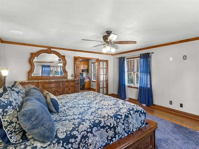 bedroom with ceiling fan, baseboards, ornamental molding, and wood finished floors