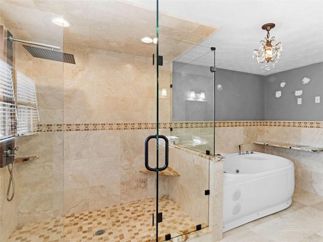 full bathroom with a bath, tile walls, a chandelier, and a stall shower
