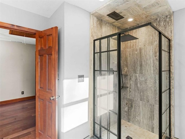full bath featuring visible vents, baseboards, wood finished floors, and a shower stall