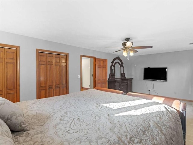 bedroom with multiple closets, ceiling fan, and visible vents
