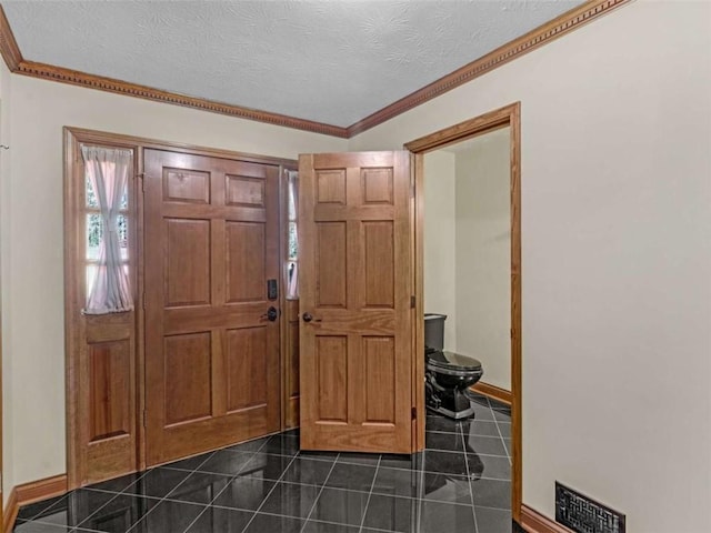 entrance foyer featuring visible vents, baseboards, and ornamental molding