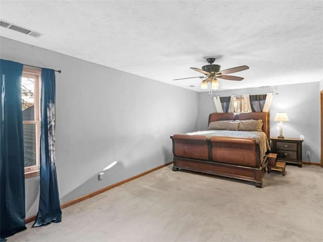 bedroom with baseboards, visible vents, carpet flooring, and ceiling fan