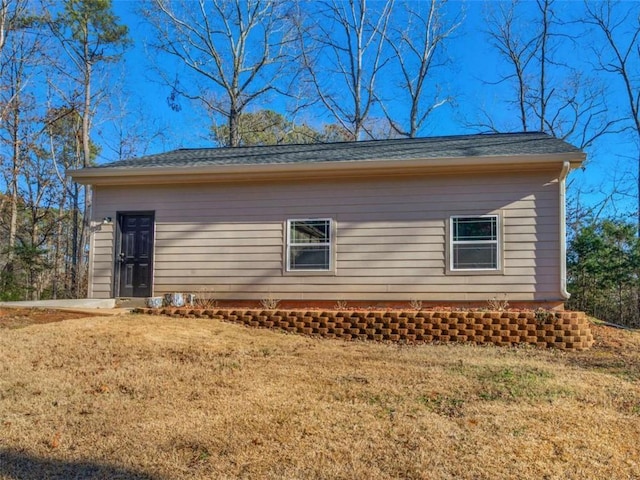 view of property exterior with a yard
