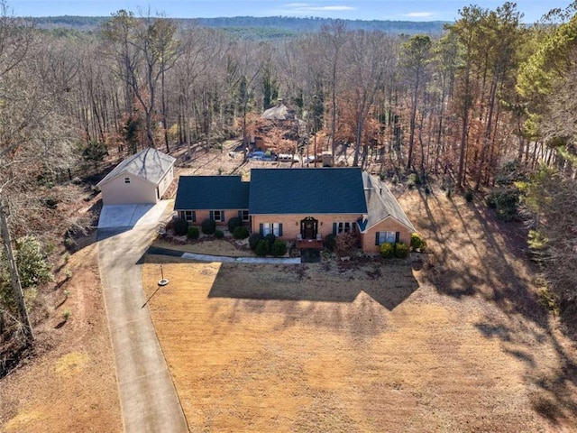 birds eye view of property with a forest view
