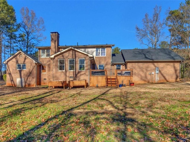 back of property featuring a chimney, a yard, and a deck
