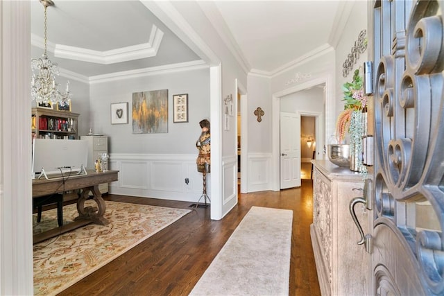 entryway with dark wood-style floors, washer / dryer, crown molding, and wainscoting