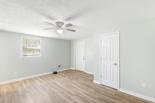 unfurnished room featuring ceiling fan, light hardwood / wood-style floors, and a textured ceiling