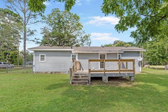 back of house with a wooden deck and a yard