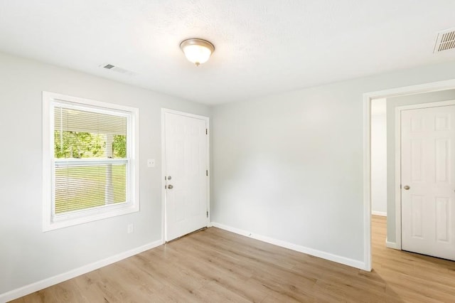 unfurnished room featuring light hardwood / wood-style floors