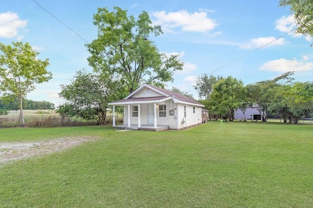 exterior space featuring a porch and a lawn