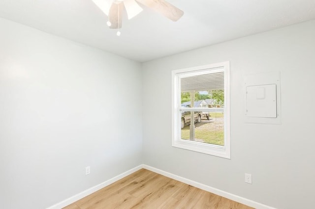 empty room featuring electric panel and hardwood / wood-style flooring