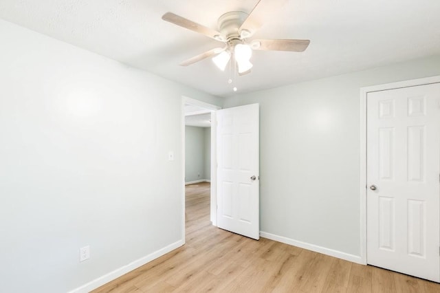 unfurnished bedroom with ceiling fan and light hardwood / wood-style floors