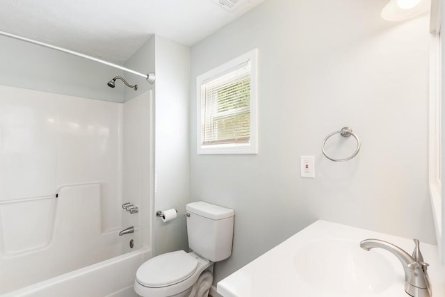 full bathroom featuring toilet, shower / washtub combination, and sink