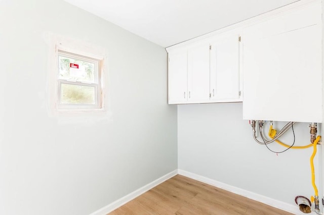 laundry area with light hardwood / wood-style floors