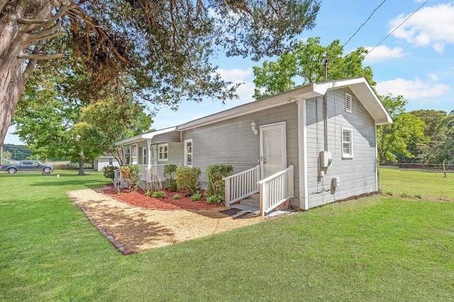 exterior space featuring a lawn and a porch