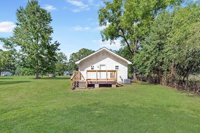 rear view of house featuring a deck and a yard