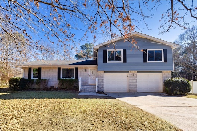 split level home featuring a garage and a front lawn