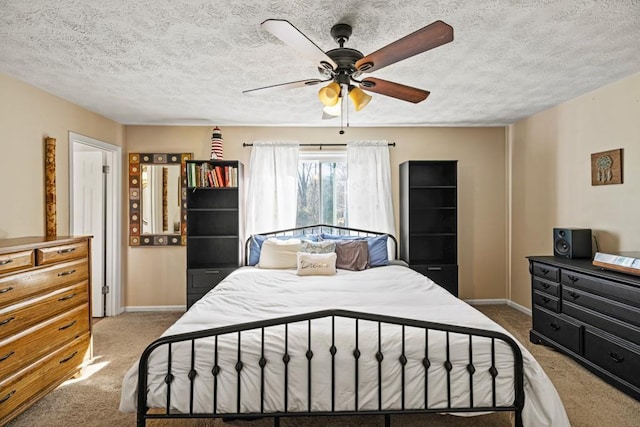 carpeted bedroom with a textured ceiling and ceiling fan