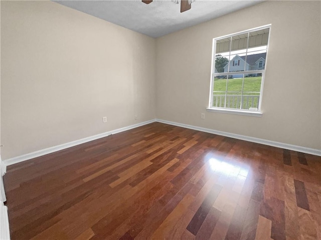 spare room with a textured ceiling, ceiling fan, and dark wood-type flooring