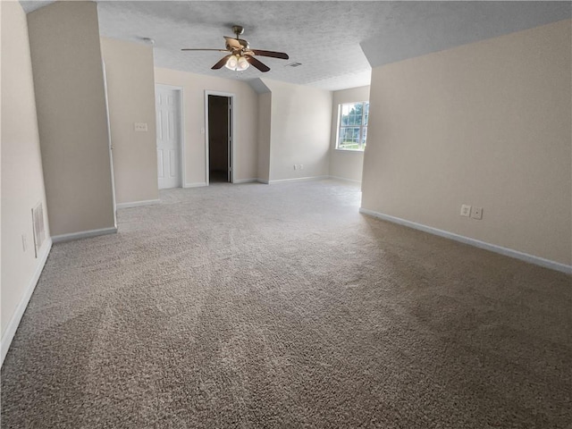 unfurnished room with a textured ceiling, carpet floors, and ceiling fan