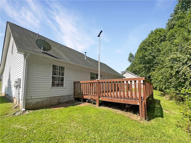 rear view of property with a lawn and a wooden deck