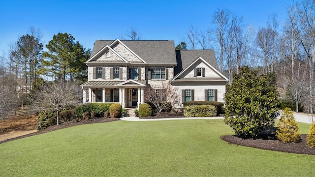 craftsman-style home with a front yard and a standing seam roof