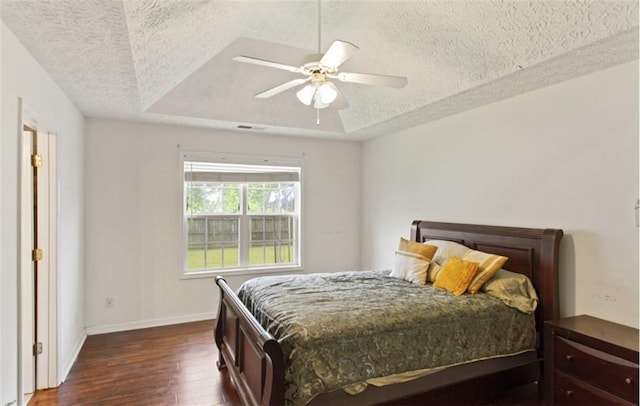 3971 Canebrake Ln, Douglasville, GA 30134 - bedroom with a textured ceiling, dark wood-style floors, baseboards, a raised ceiling, and a ceiling fan