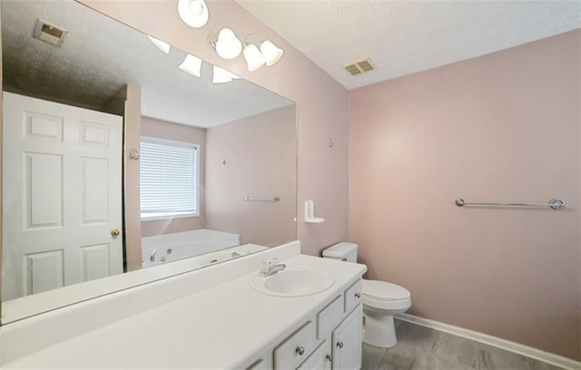 3971 Canebrake Ln, Douglasville, GA 30134 - bathroom with toilet, a garden tub, vanity, a textured ceiling, and baseboards