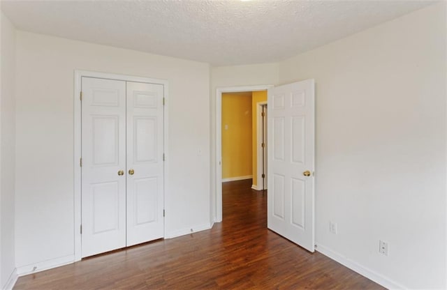 3971 Canebrake Ln, Douglasville, GA 30134 - unfurnished bedroom with wood finished floors, a closet, baseboards, and a textured ceiling