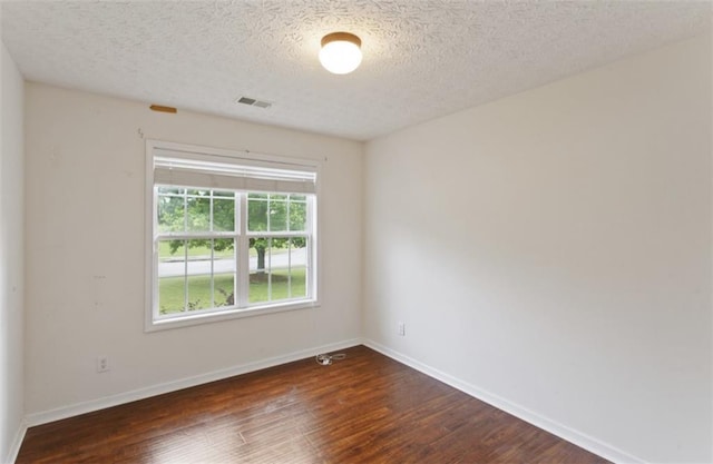 3971 Canebrake Ln, Douglasville, GA 30134 - spare room featuring dark wood-style floors, baseboards, and a textured ceiling