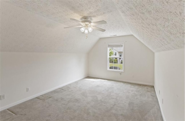 3971 Canebrake Ln, Douglasville, GA 30134 - additional living space featuring a textured ceiling, carpet flooring, baseboards, lofted ceiling, and ceiling fan