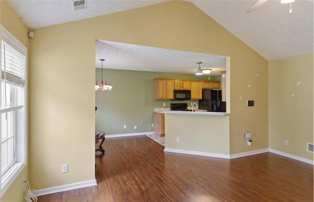 3971 Canebrake Ln, Douglasville, GA 30134 - unfurnished living room with vaulted ceiling, dark wood finished floors, a textured ceiling, a ceiling fan, and baseboards