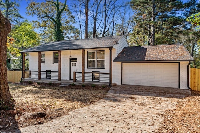 bi-level home featuring a porch and a garage