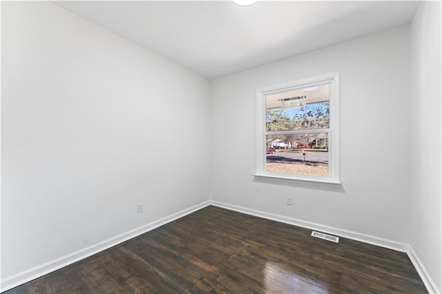 empty room with dark wood-type flooring