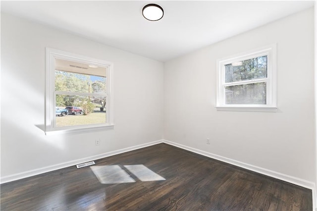 empty room with dark wood-type flooring